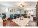 Inviting living room boasts hardwood floors, a plush area rug, and ample seating, perfect for relaxation and entertaining guests at 693 Carybrook Ct, York, SC 29745