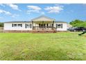 Charming ranch-style home with a welcoming front porch, lush lawn, and classic white siding at 7990 W Nc 152 Hwy, Mooresville, NC 28115