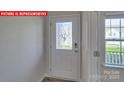 The foyer features a decorative glass front door that floods the area with light at 8036 Kennesaw Dr, Gastonia, NC 28056