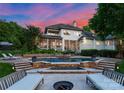 Gorgeous home exterior featuring a luxurious pool, spa, and lounge area for outdoor relaxation at 8813 Covey Rise Ct, Charlotte, NC 28226