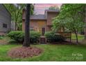 Charming two-story home featuring a spacious deck and lush greenery in the backyard at 8968 St Croix Ln, Charlotte, NC 28277