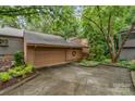 Exterior shot featuring the home's attached two-car garage, driveway, and well-maintained landscaping at 8968 St Croix Ln, Charlotte, NC 28277
