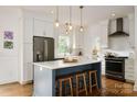 Modern kitchen featuring white cabinets, a center island, and stainless steel appliances at 943 Shinnville Rd, Mooresville, NC 28115