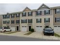 A view of the townhome complex featuring individual garages and covered front door entries at 954 Taybyn Rd, Fort Mill, SC 29715