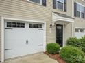 Close up of a townhome with attached one car garage and covered front door entry with landscaping at 954 Taybyn Rd, Fort Mill, SC 29715
