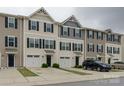 A view of the townhome complex featuring individual garages and covered front door entries at 954 Taybyn Rd, Fort Mill, SC 29715