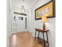 Elegant foyer with hardwood floors, a decorative table, and a view of the bright, welcoming entryway at 9833 Ardley Park Way, Mint Hill, NC 28227