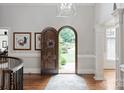 Bright foyer featuring gleaming wood floors, a decorative rug, and an arched wood doorway at 1032 Seminole Dr, Waxhaw, NC 28173