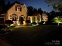 Charming home with exterior lighting highlighting the architectural details at night at 1032 Seminole Dr, Waxhaw, NC 28173
