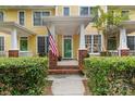 Welcoming front porch of a townhome, adorned with an American flag and vibrant green door at 1123 Market St, Fort Mill, SC 29708