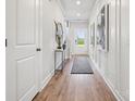 Bright entryway with wood floors, white walls, stylish console table, and view of the front door at 1237 Margo Mannor Dr, Fort Mill, SC 29708