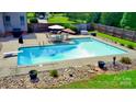 Inviting backyard pool with diving board and patio area, perfect for relaxation and entertaining at 141 Weathers Creek Rd, Troutman, NC 28166