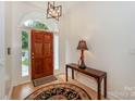Inviting foyer features hardwood floors, elegant lighting, and a stylish entry table at 14831 Charterhouse Ln, Huntersville, NC 28078