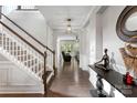 Elegant entryway with hardwood floors, white trim, and staircase leading to upper level at 15416 Oleander Dr, Charlotte, NC 28278