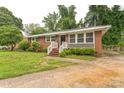 Inviting single-story brick home with well-maintained landscaping, featuring a bright entrance and cozy atmosphere at 1631 Vancouver Dr, Charlotte, NC 28213