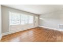 Bright living room featuring large windows and hardwood floors at 1631 Vancouver Dr, Charlotte, NC 28213