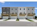 Townhome back view with garages, upper decks, and complementary landscaping at 1948 Westerhill Dr, Fort Mill, SC 29708