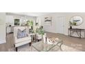 Open concept living space featuring modern furniture, hardwood floors, and natural light throughout at 212 Queens Ct, Gastonia, NC 28052