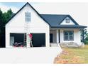 New construction home featuring white siding, dark roof, covered porch and an attached two car garage at 2589 Polo Ln, Maiden, NC 28650