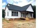 New construction home featuring white siding, dark roof, covered porch and wood deck at 2589 Polo Ln, Maiden, NC 28650
