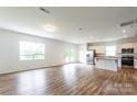 Spacious living area filled with natural light, featuring wood-look floors and a seamless flow to the kitchen at 3073 Langhorne Sw Ave, Concord, NC 28027