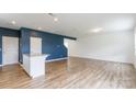 Open-concept living space with wood-look floors, recessed lighting, and a stylish accent wall at 3073 Langhorne Sw Ave, Concord, NC 28027