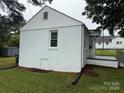 White brick home featuring a window and a small basement door at 317 Heilig Ave, Salisbury, NC 28144