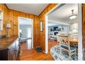 Warm entryway featuring hardwood floors, wood paneling, and a seamless transition to the open-concept living spaces at 3447 Filbert Hwy, Clover, SC 29710