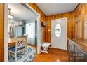 Charming entryway with wood paneling, hardwood floors, and a view into the adjacent kitchen and dining area at 3447 Filbert Hwy, Clover, SC 29710