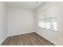 A room with hardwood floors and white walls with a window at 347 Carolina Hemlock Dr # 141, Locust, NC 28097