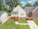 Inviting two-story home with manicured front lawn, showcasing its charming curb appeal on a bright, sunny day at 5111 Clearwater Rd, Charlotte, NC 28217