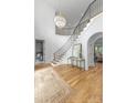 Sun-filled foyer with hardwood floors, chandelier lighting and grand staircase at 5127 Lansing Dr, Charlotte, NC 28270