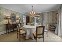 Formal dining room with decorative wallpaper, chandelier, and elegant furnishings at 640 Colville Rd, Charlotte, NC 28207