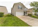 Charming two-story home featuring a well-maintained lawn and a convenient attached two-car garage at 673 Shellbark Dr, Concord, NC 28025