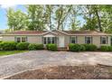Inviting home with gravel driveway, manicured shrubs, and well-maintained lawn providing a welcoming entrance at 7232 Executive Cir, Denver, NC 28037
