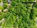 Aerial view of a 2.25 acre lot surrounded by mature trees in a residential area at 7949 Ritter Dr, Charlotte, NC 28270