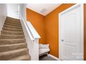 Stairway with carpeted steps, white banister, and an accent wall at 826 Sinclair Dr, Monroe, NC 28112
