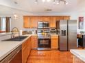 Functional kitchen with stainless steel appliances, wood cabinets, and countertop space at 9348 Golden Pond Dr, Charlotte, NC 28269