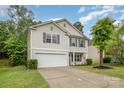 Charming two-story home with gray shutters, vinyl siding, manicured lawn and two-car garage at 9524 Eagle Feathers Dr, Charlotte, NC 28214