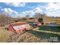 Aerial view of rustic barns and outbuildings on a sprawling, grassy property at 956 Stony Point Rd, Kings Mountain, NC 28086