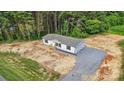 Aerial view of the home showcasing its location, surrounding greenery, and gravel driveway at 977 Myers Mill Rd, Olin, NC 28660