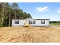 Newly constructed one-story home features bright, white siding and a wooden porch at 977 Myers Mill Rd, Olin, NC 28660