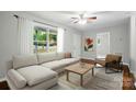 Bright living room featuring hardwood floors, neutral paint, and a large window with natural light at 107 S Branch St, Monroe, NC 28112