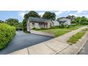 Property featuring a lengthy driveway, beautiful lawn, and mature trees providing plenty of shade at 1125 Bethel Rd, Charlotte, NC 28208