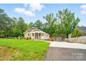 Inviting home with a well-manicured lawn, covered porch, and detached garage in the back at 1209 Rainbow Dr, Kannapolis, NC 28081