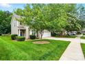Beautiful two-story home boasting a lush green lawn, mature trees, and a two-car garage at 147 Whitley Mills Rd, Fort Mill, SC 29708