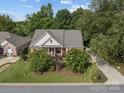 Charming brick home with a manicured lawn, lush landscaping and inviting curb appeal at 1525 Valhalla Dr, Denver, NC 28037