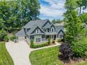 Beautiful exterior showcasing a large two-story home with a three-car garage and well-manicured lawn at 208 South Shore Dr, Belmont, NC 28012