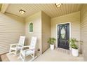 Inviting front porch features two white rocking chairs and a beautifully decorated front door at 268 Hillsborough Ln, Rock Hill, SC 29732