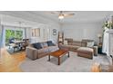 Comfortable living room with two sofas, a ceiling fan and view of the dining area at 2934 Drakes Crossing Dr, Charlotte, NC 28262